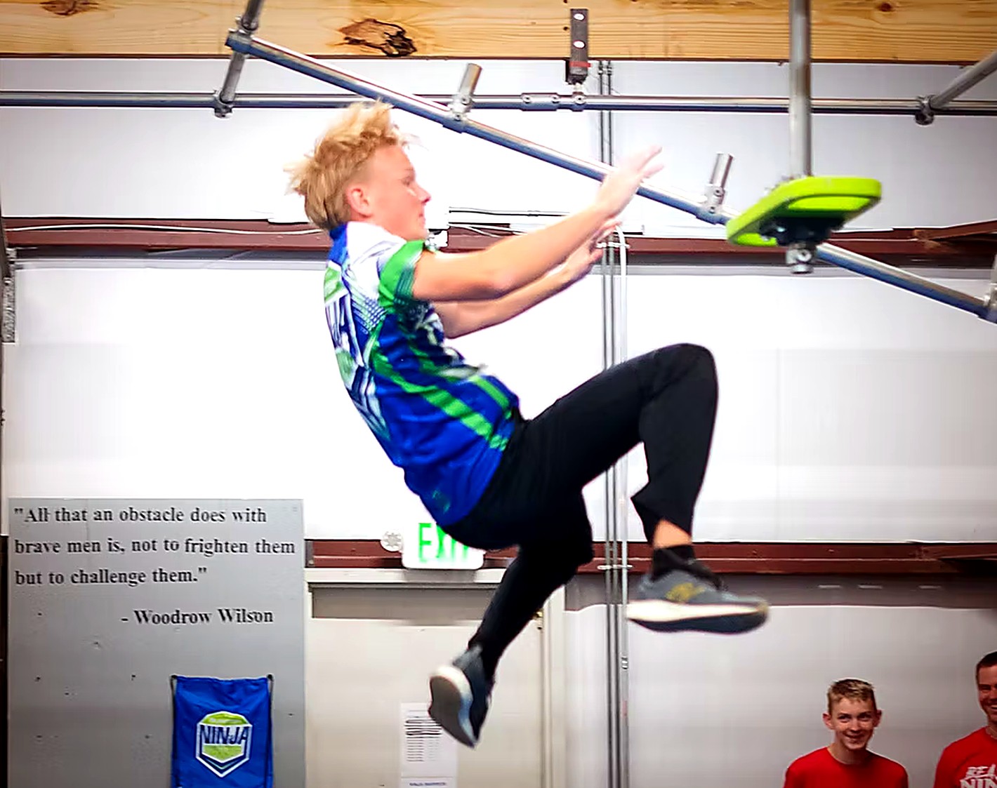Ninja warrior athlete swinging through an obstacle course