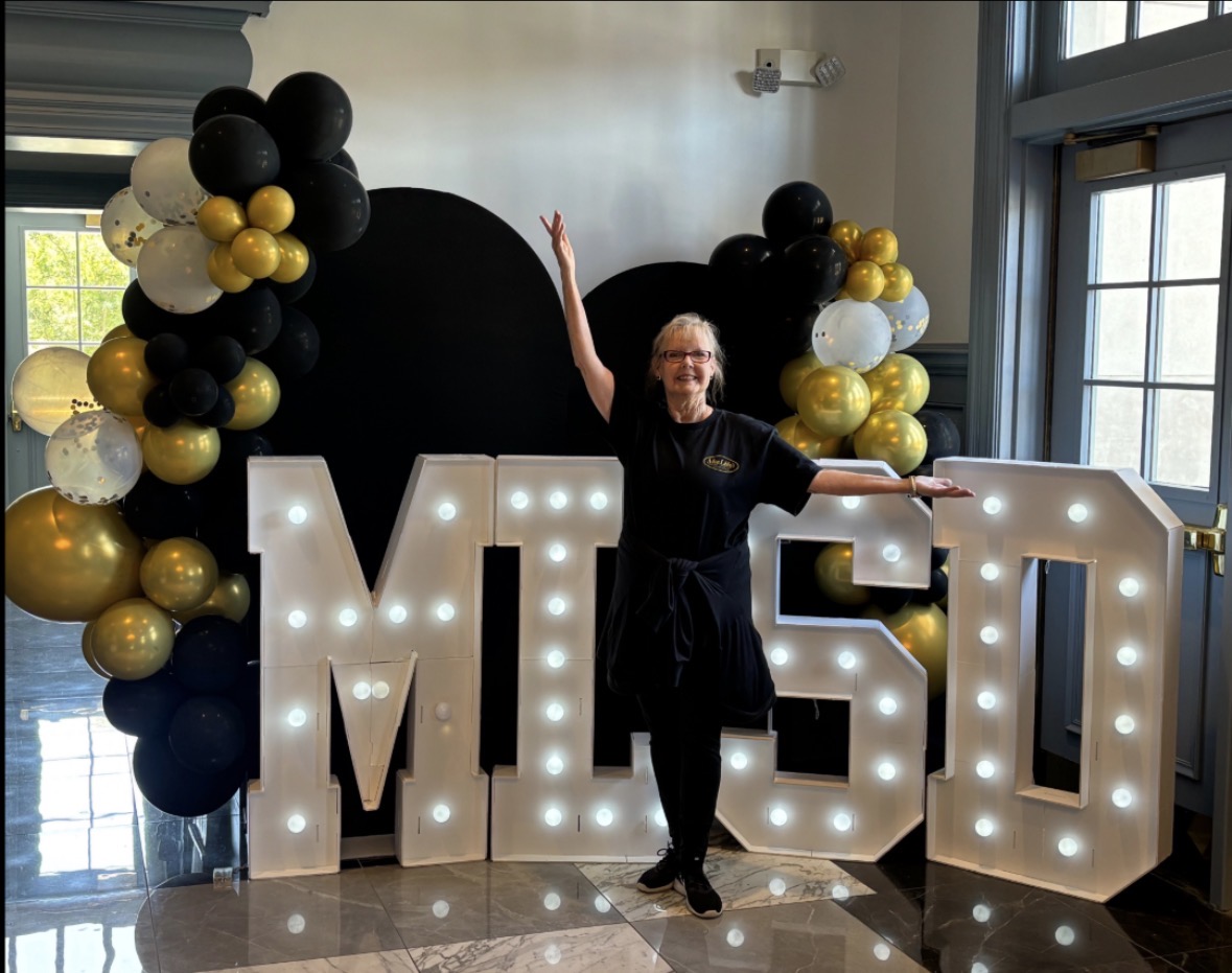 Miss Libby with illuminated letters and balloon display