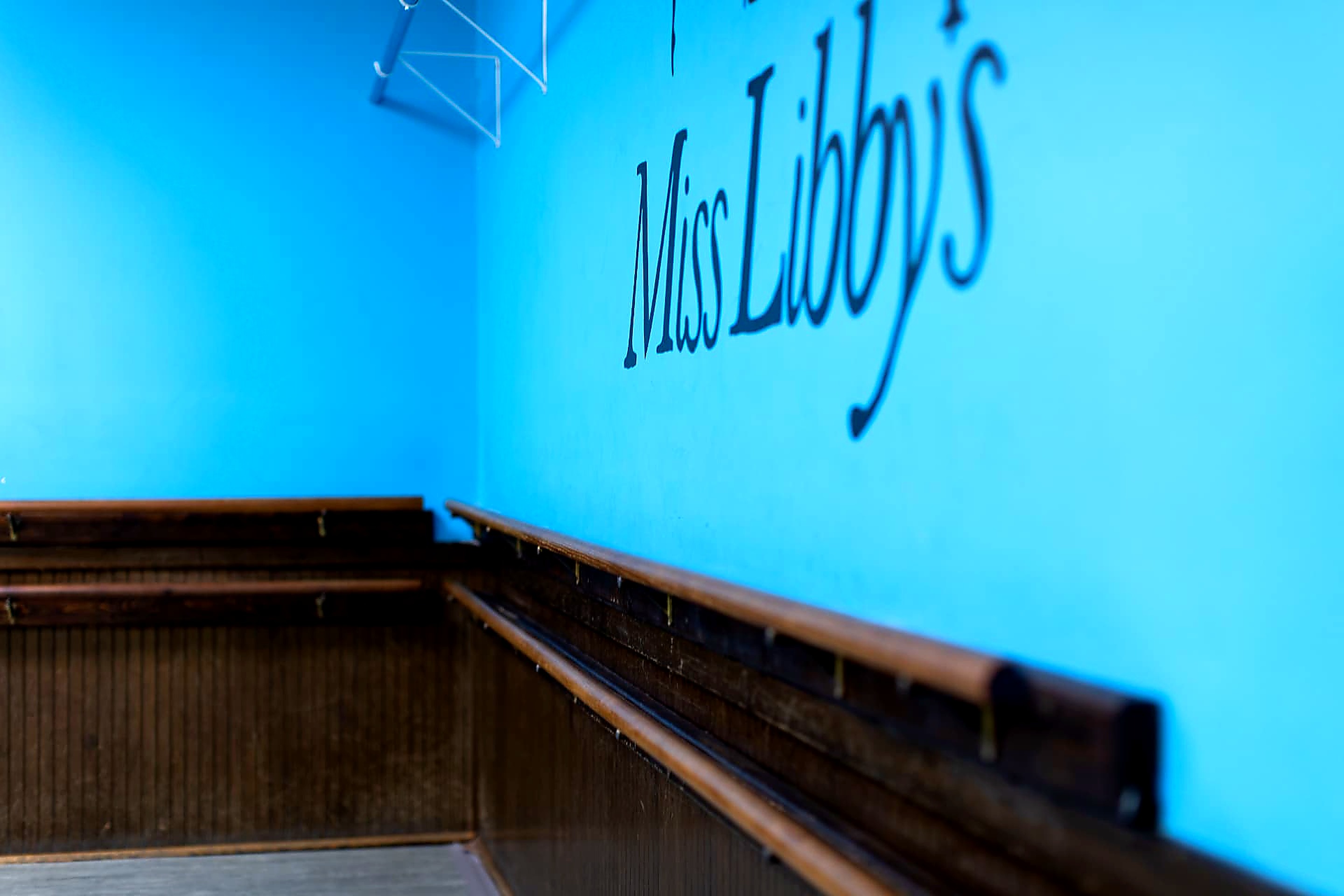 Close-up of the Miss Libby's hand-painted studio wall lettering