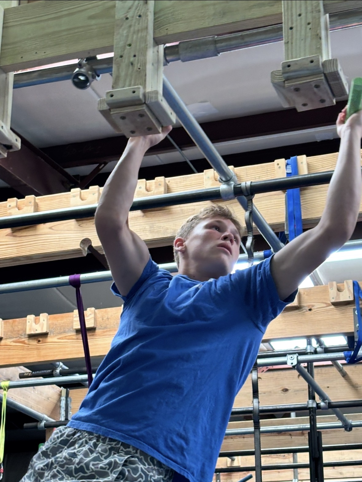 Ninja warrior athlete on obstacles at Miss Libby's