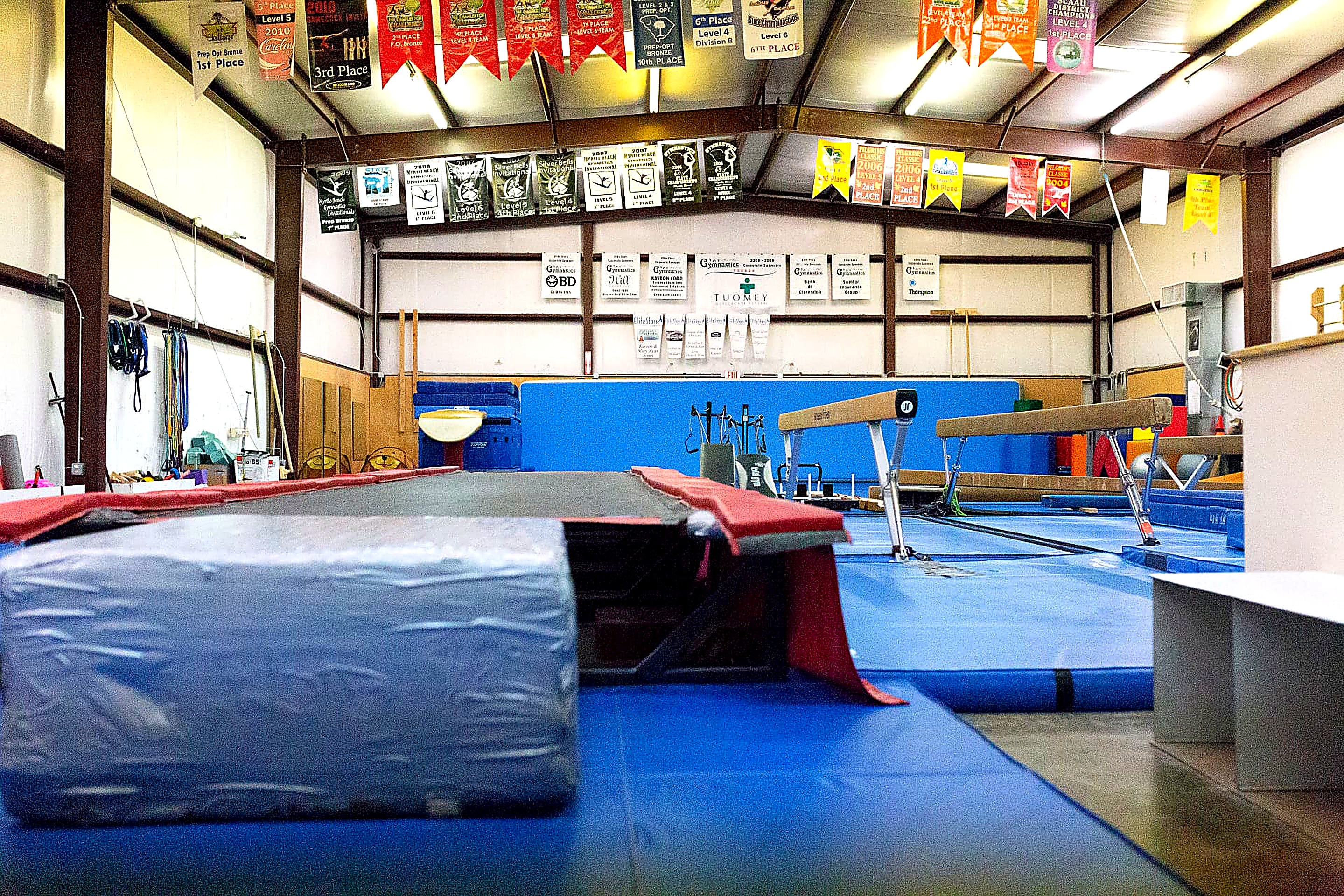 Competition banners above the beams and vault runway